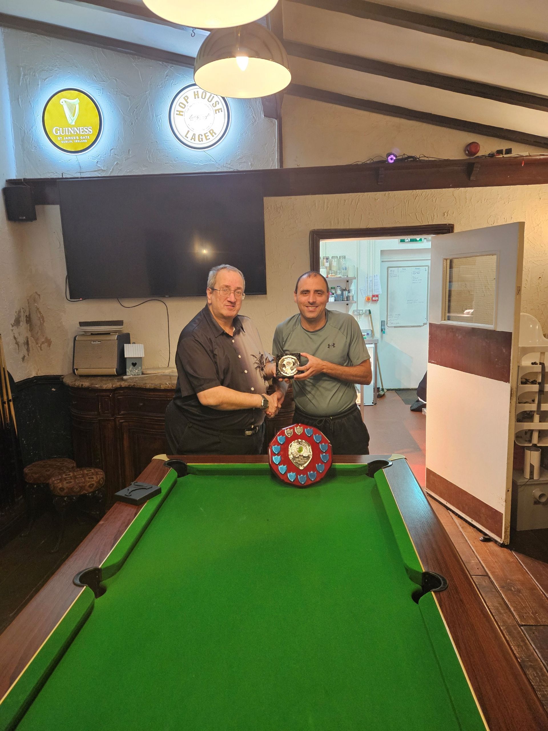 Conquering Heroes’ Team Captain John Dellafera (left) presents the Geoff Gatt Memorial Trophy for the team’s Most Valuable Player in the 2024 season to Kevin Dempsey (right) who won it in his first season with the team.
