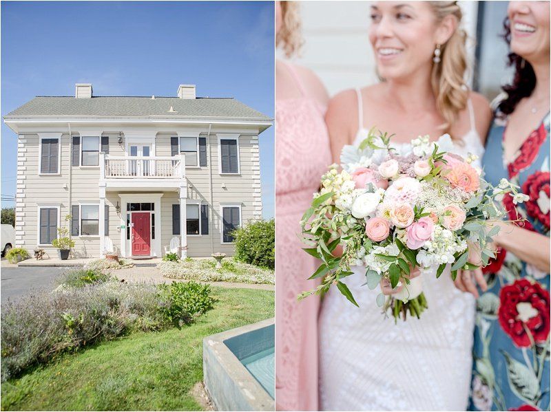 A bride and her bridesmaids are standing in front of a white house holding a bouquet of flowers.