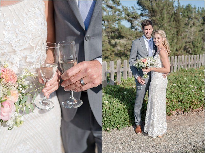 A bride and groom are posing for a picture while the bride is holding a glass of champagne.