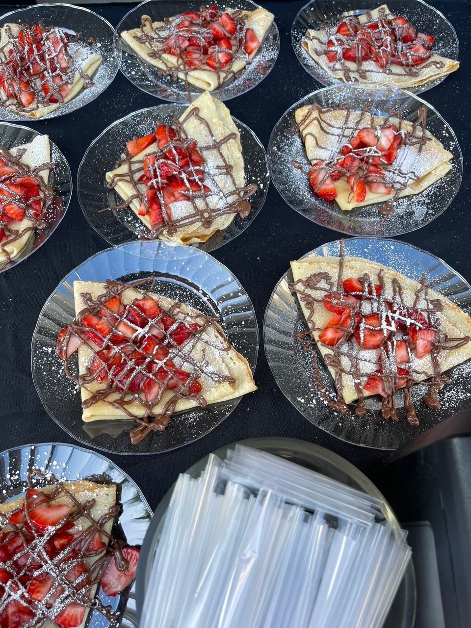 A bunch of plates of food with strawberries on them