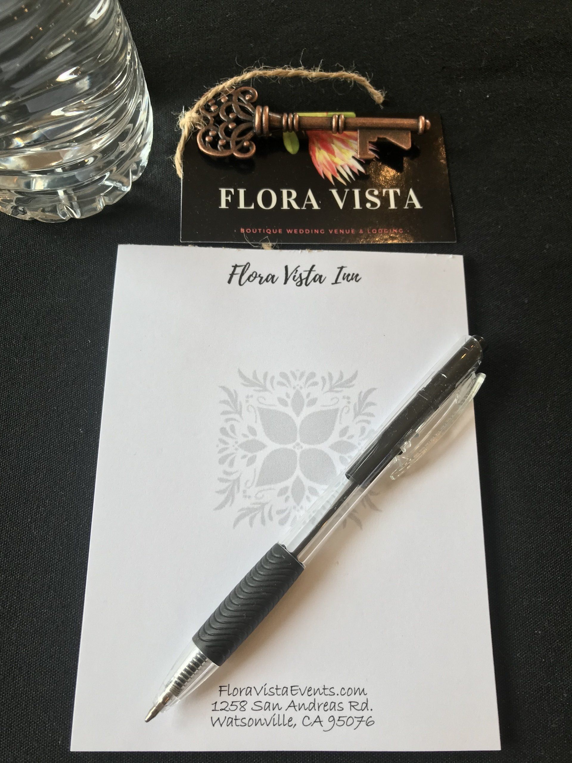 A pen sits on a notepad that says flora vista