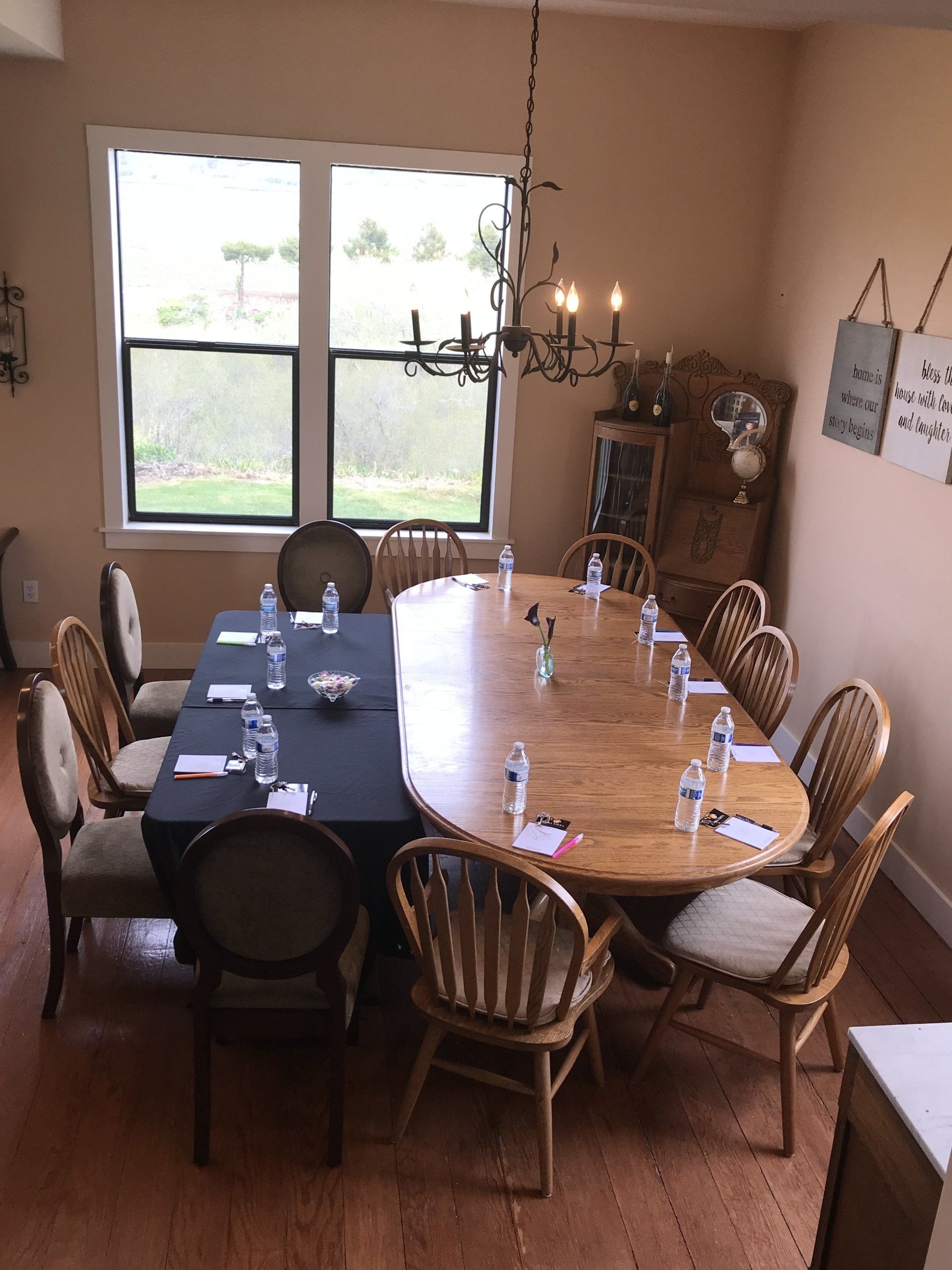A room with a long table and chairs set up for a meeting.