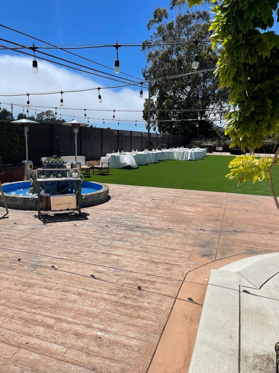 A patio with a fountain in the middle of it