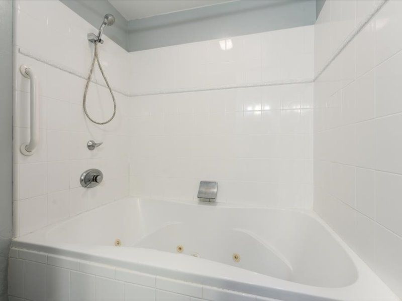 A bathroom with a jacuzzi tub and a shower.