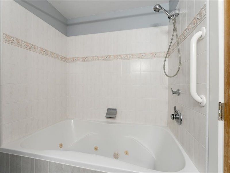 A bathroom with a jacuzzi tub and a shower