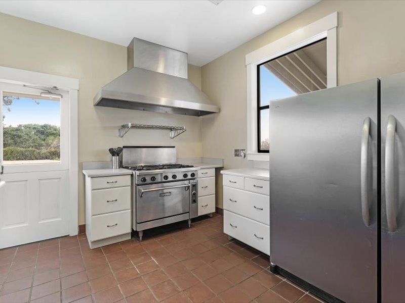 A kitchen with stainless steel appliances and white cabinets