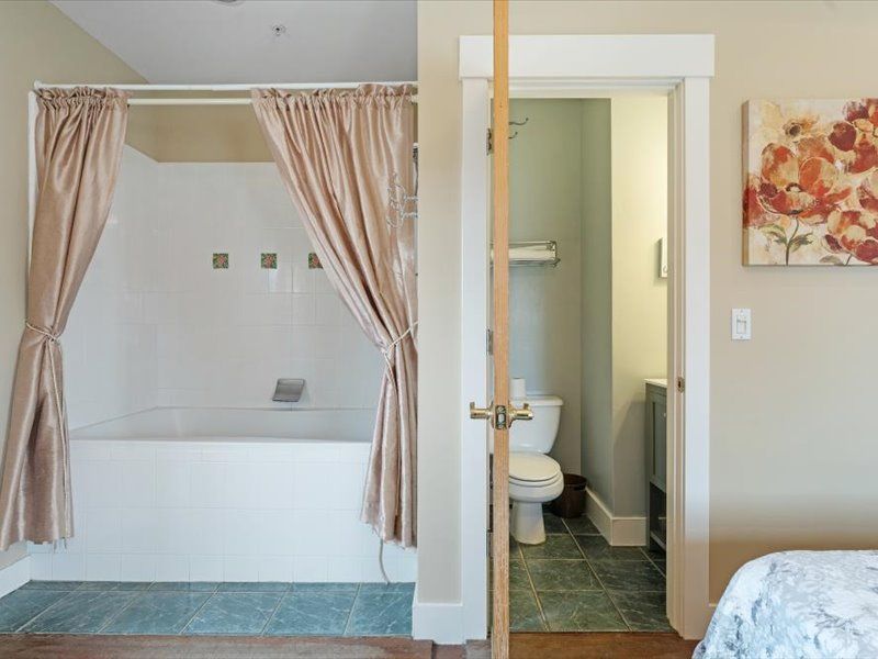 A bathroom with a bathtub and a toilet