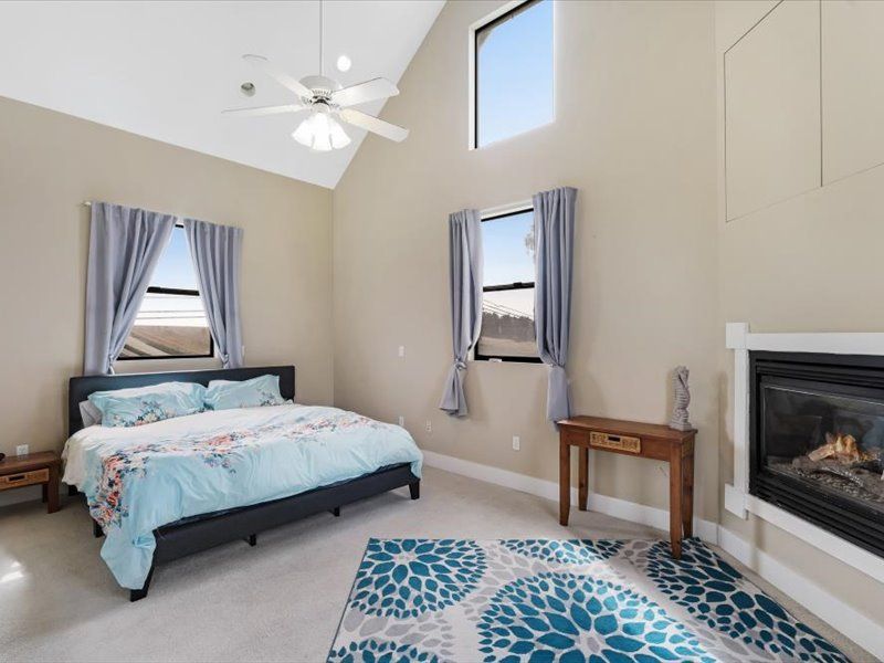 A bedroom with a king size bed and a fireplace