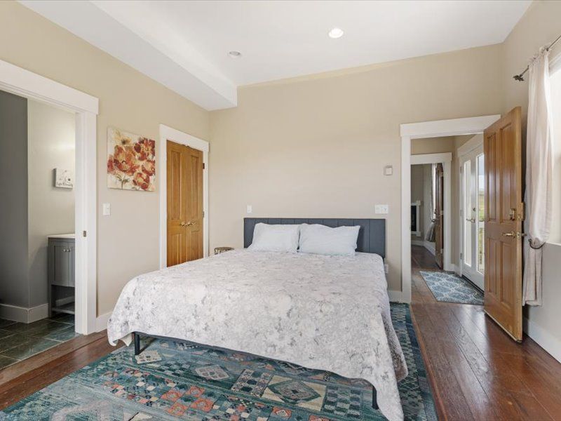 A bedroom with a king size bed and a rug