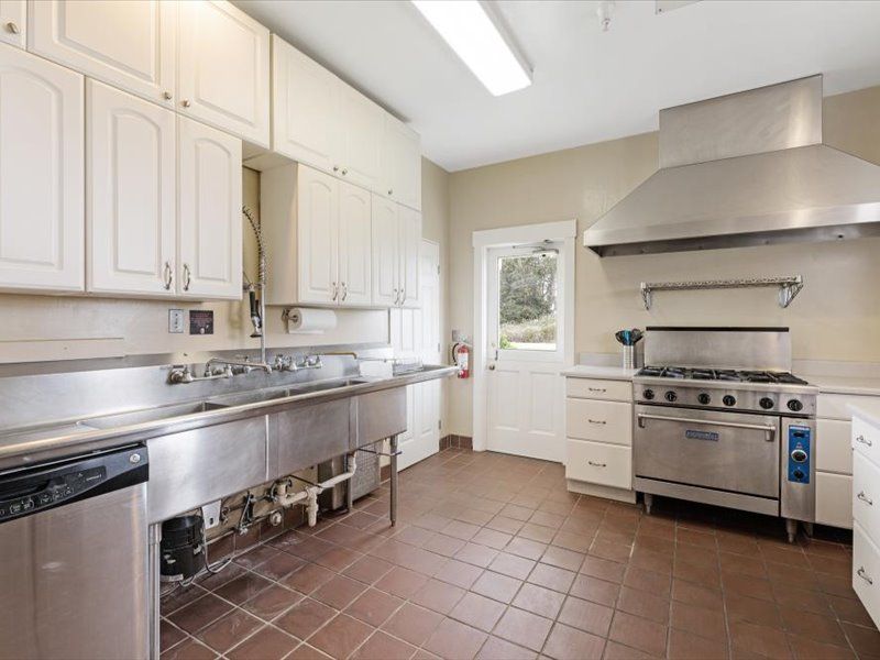 A kitchen with stainless steel appliances and white cabinets