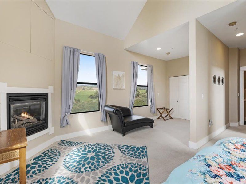 A bedroom with a fireplace , chair , and rug.