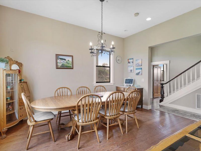 A dining room with a table and chairs and a chandelier