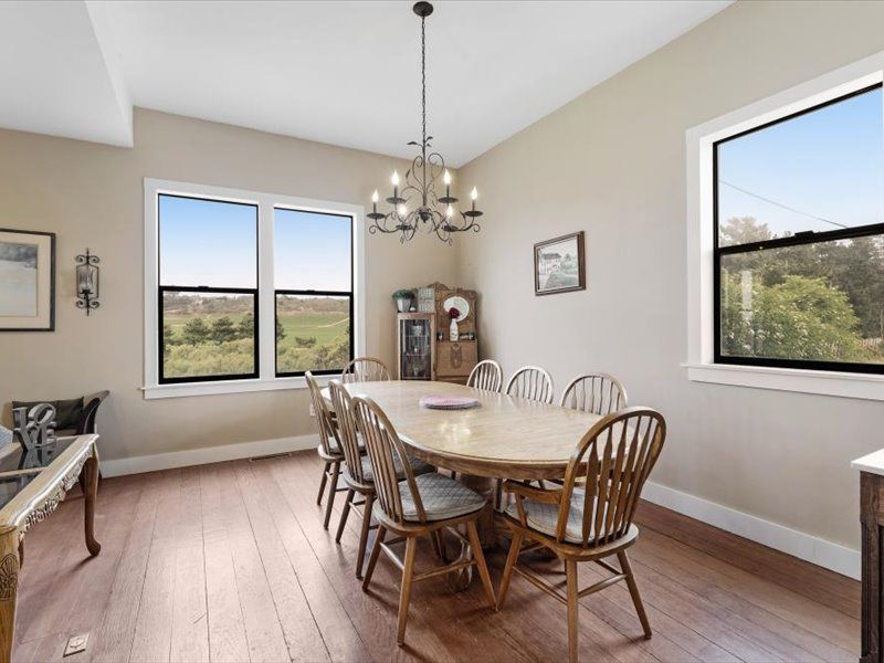 A dining room with a table and chairs and a chandelier.