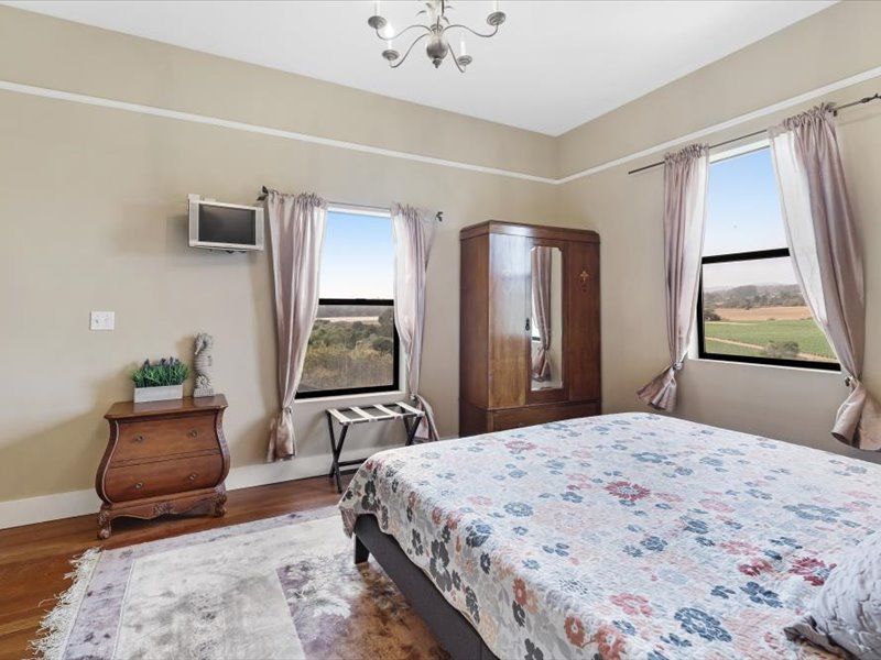 A bedroom with a king size bed and a television