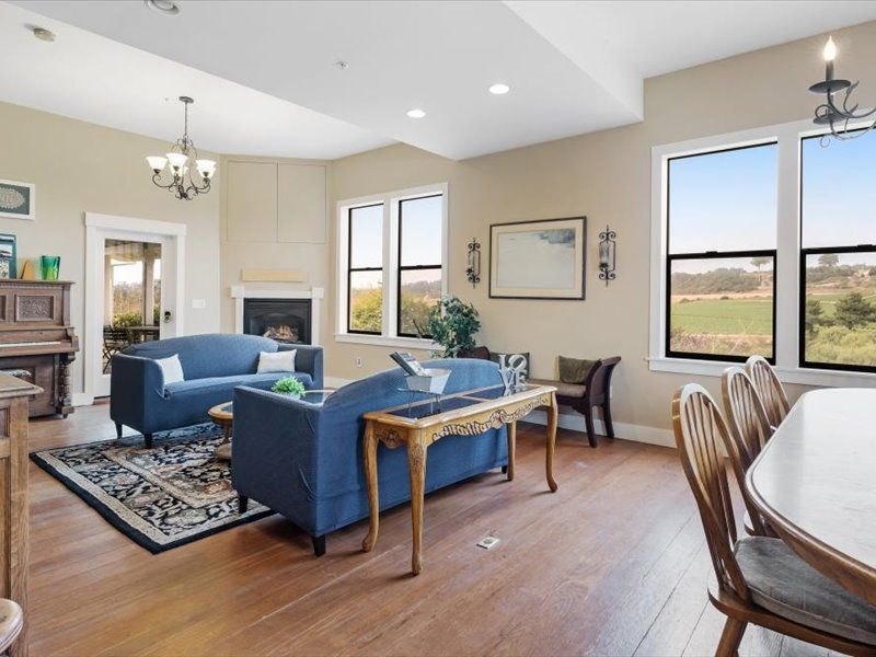 A living room with a blue couch and a piano