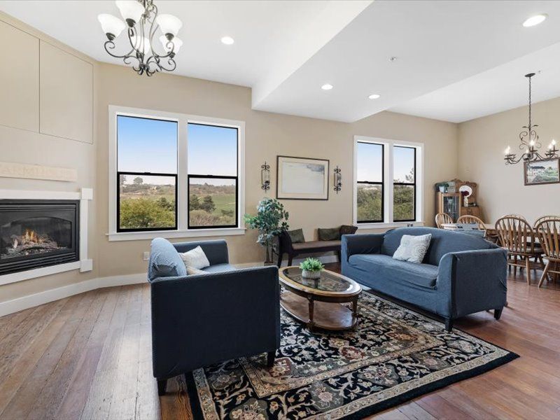 A living room with two couches and a fireplace