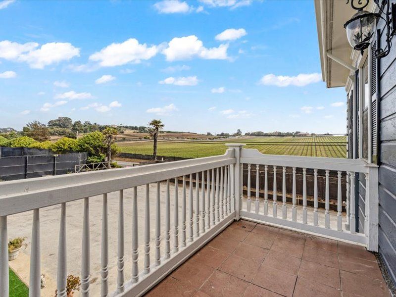 There is a balcony with a view of a field.
