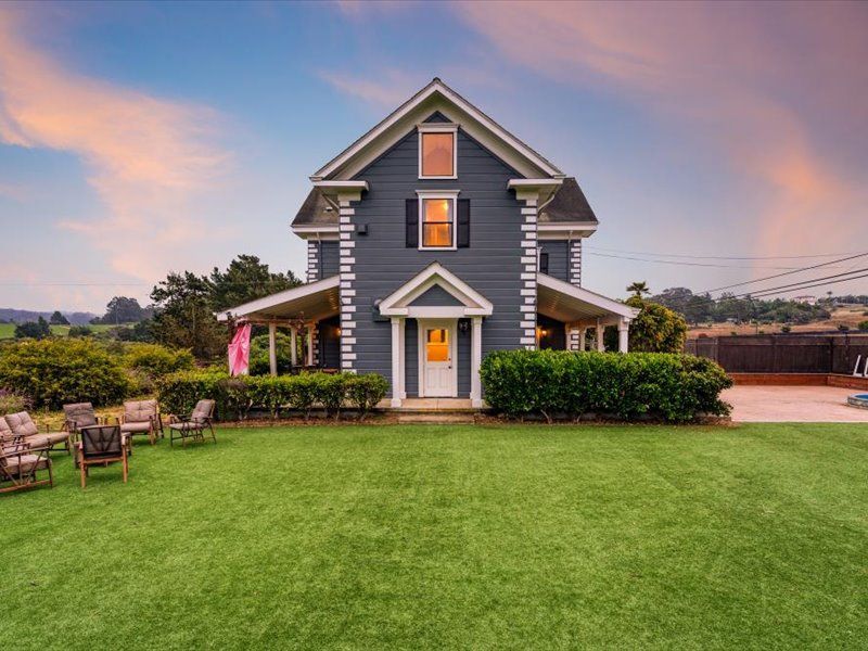 A large house with a large lawn in front of it.