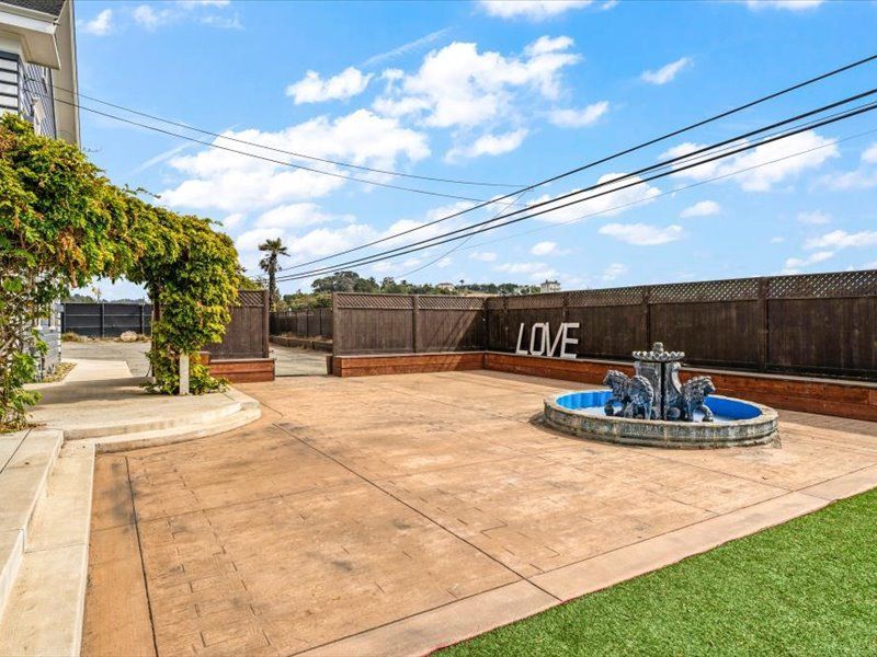 There is a fountain in the middle of the driveway.