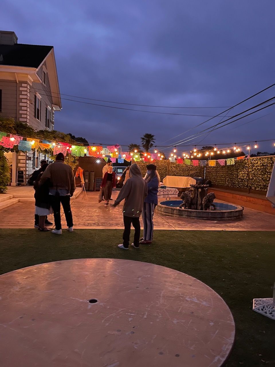 A group of people are standing in front of a house.