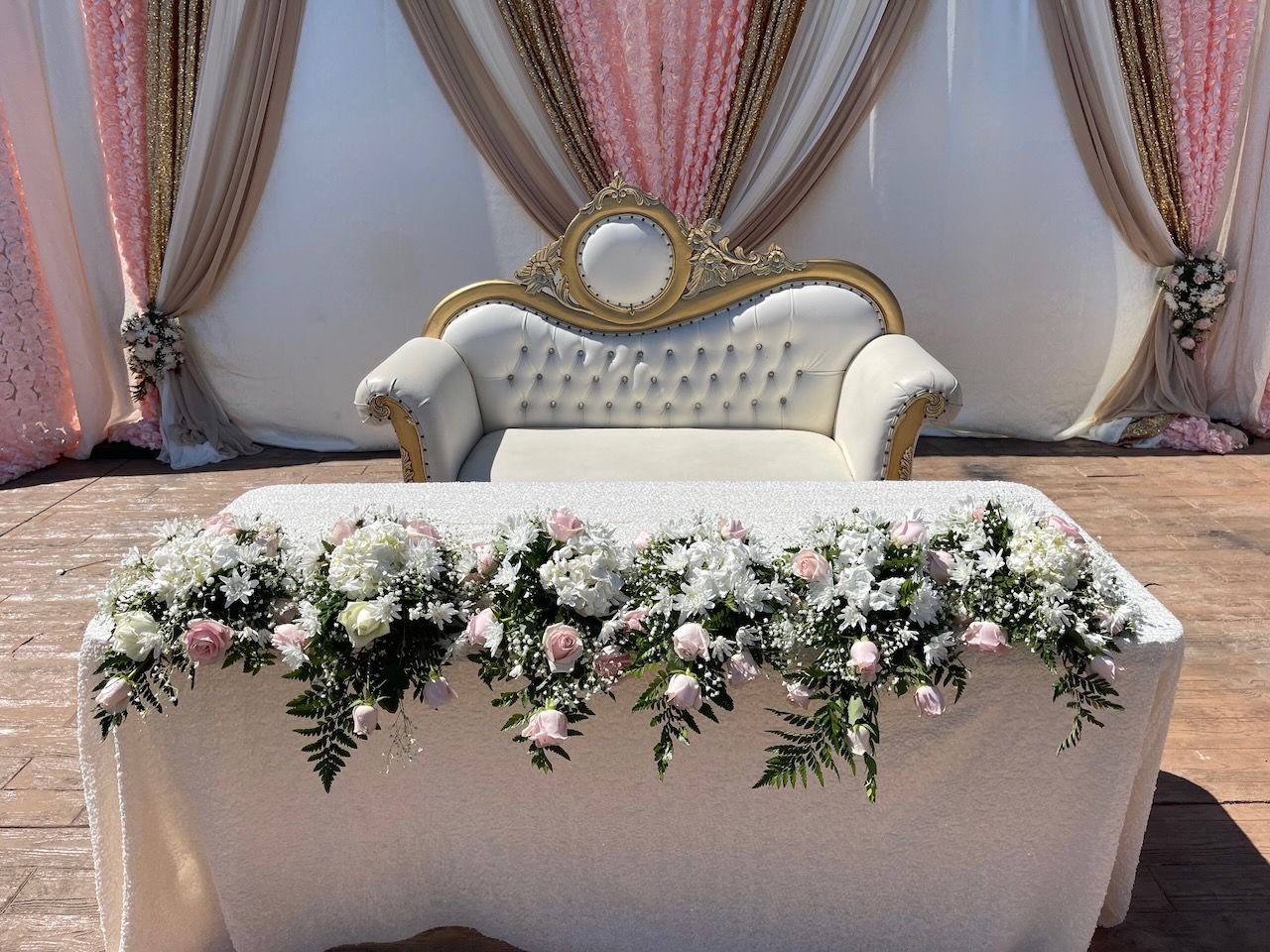A table with flowers on it and a couch in the background