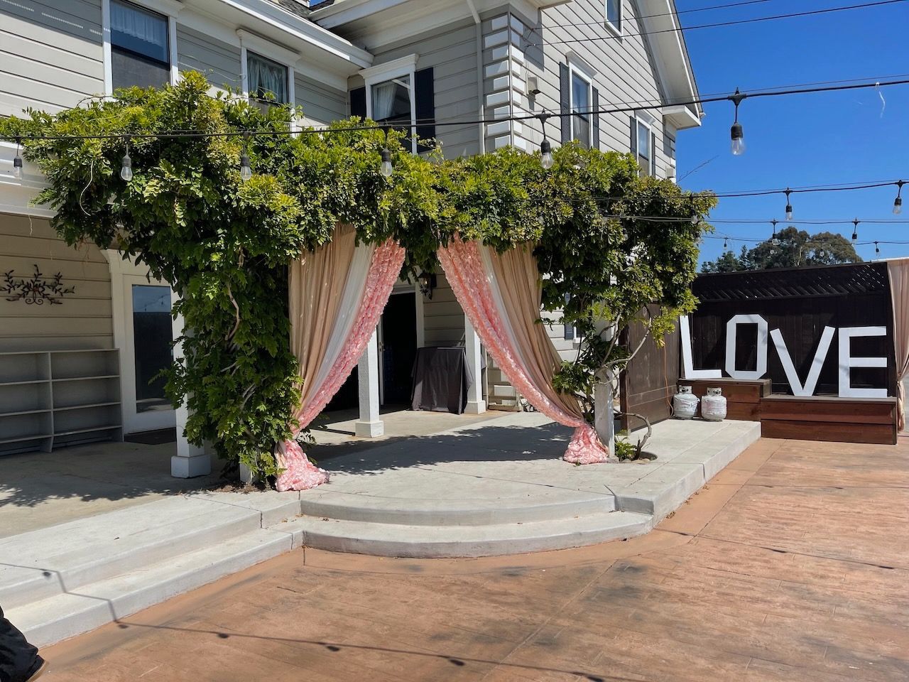 A large sign that says love is in front of a house.