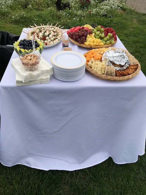 A table with plates and bowls of food on it