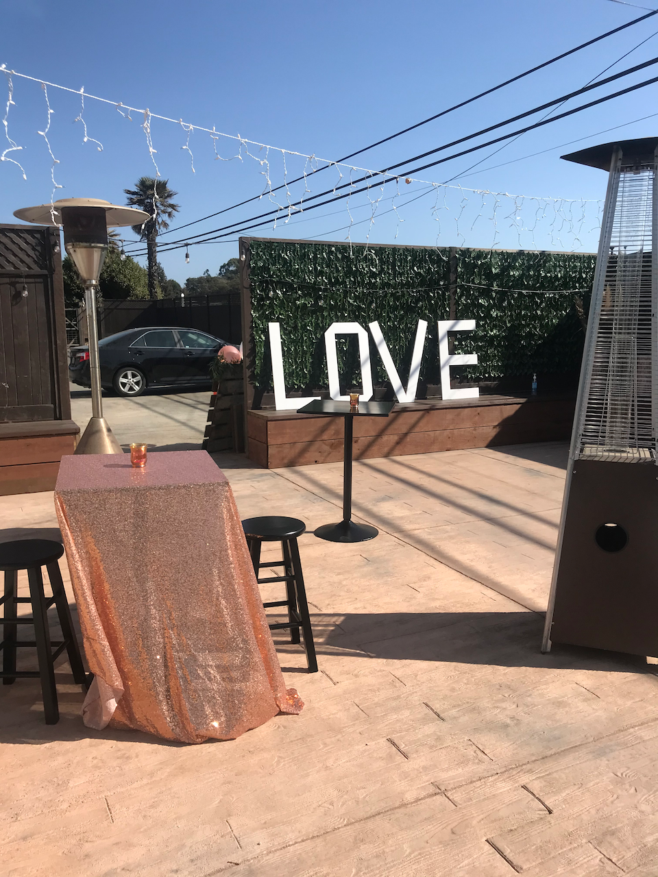 A patio with a table and chairs and a sign that says love.