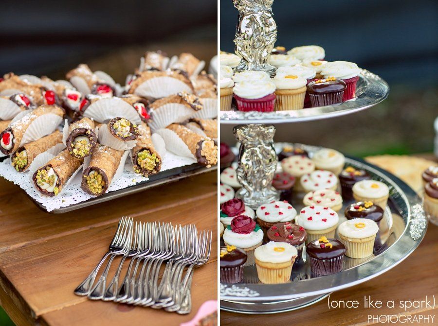 A tray of cannoli and a tray of cupcakes on a table.