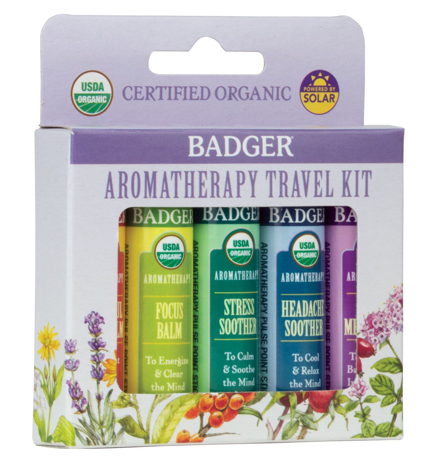 Badger aromatherapy travel kit with four balm tubes, each labeled for a different purpose. The box has a botanical design and USDA organic certification.
