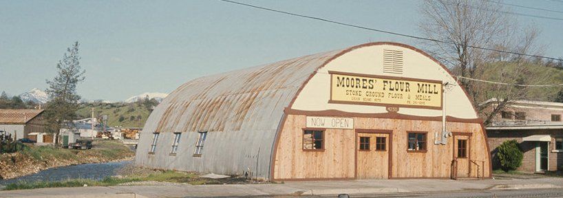 A rustic, arched-roofed building, 