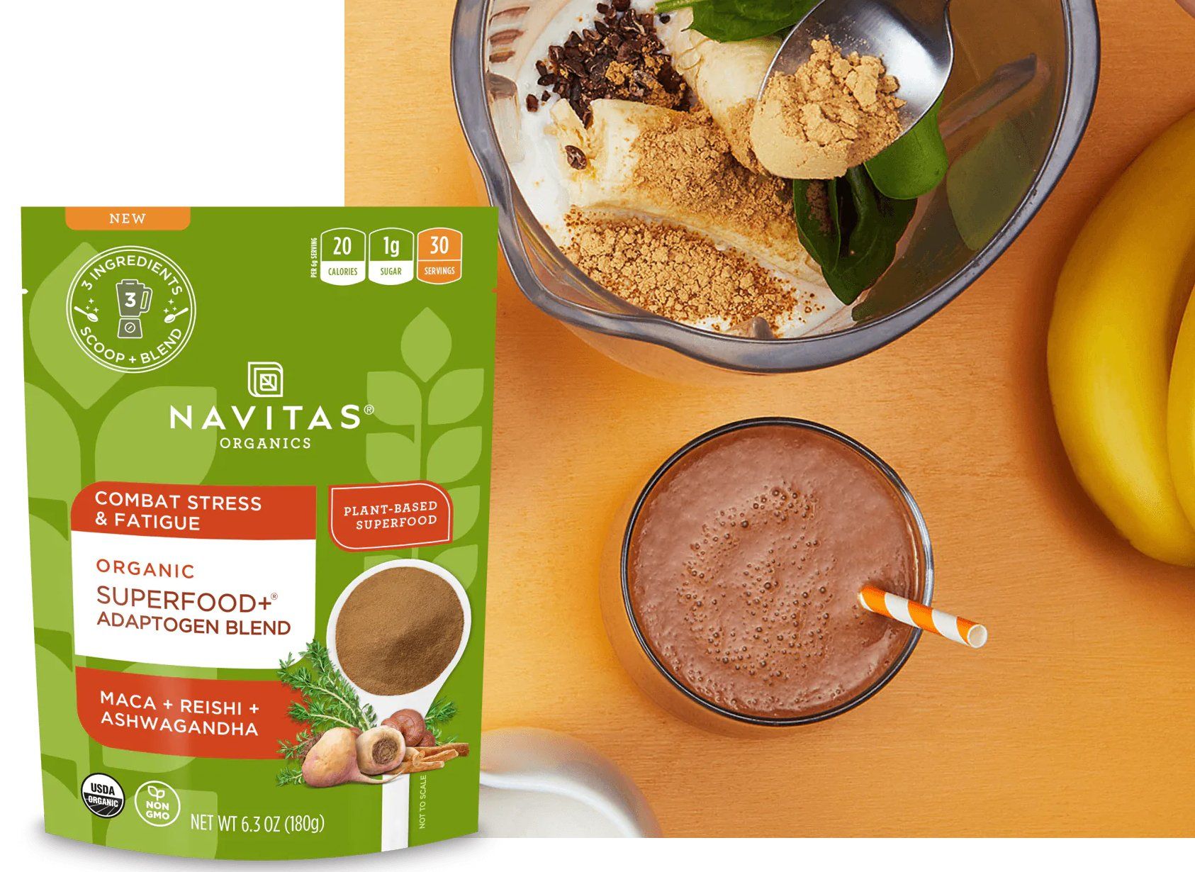 A green bag of Navitas Organic Superfood powder next to a smoothie in a glass, with ingredients like banana and cocoa.