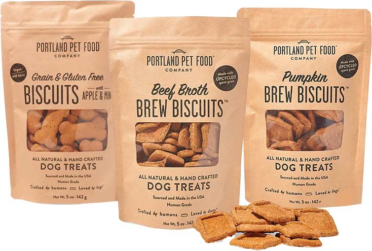 Three bags of Portland Pet Food Company dog treats: Grain & Apple, Beef Broth, and Pumpkin Brew Biscuits.