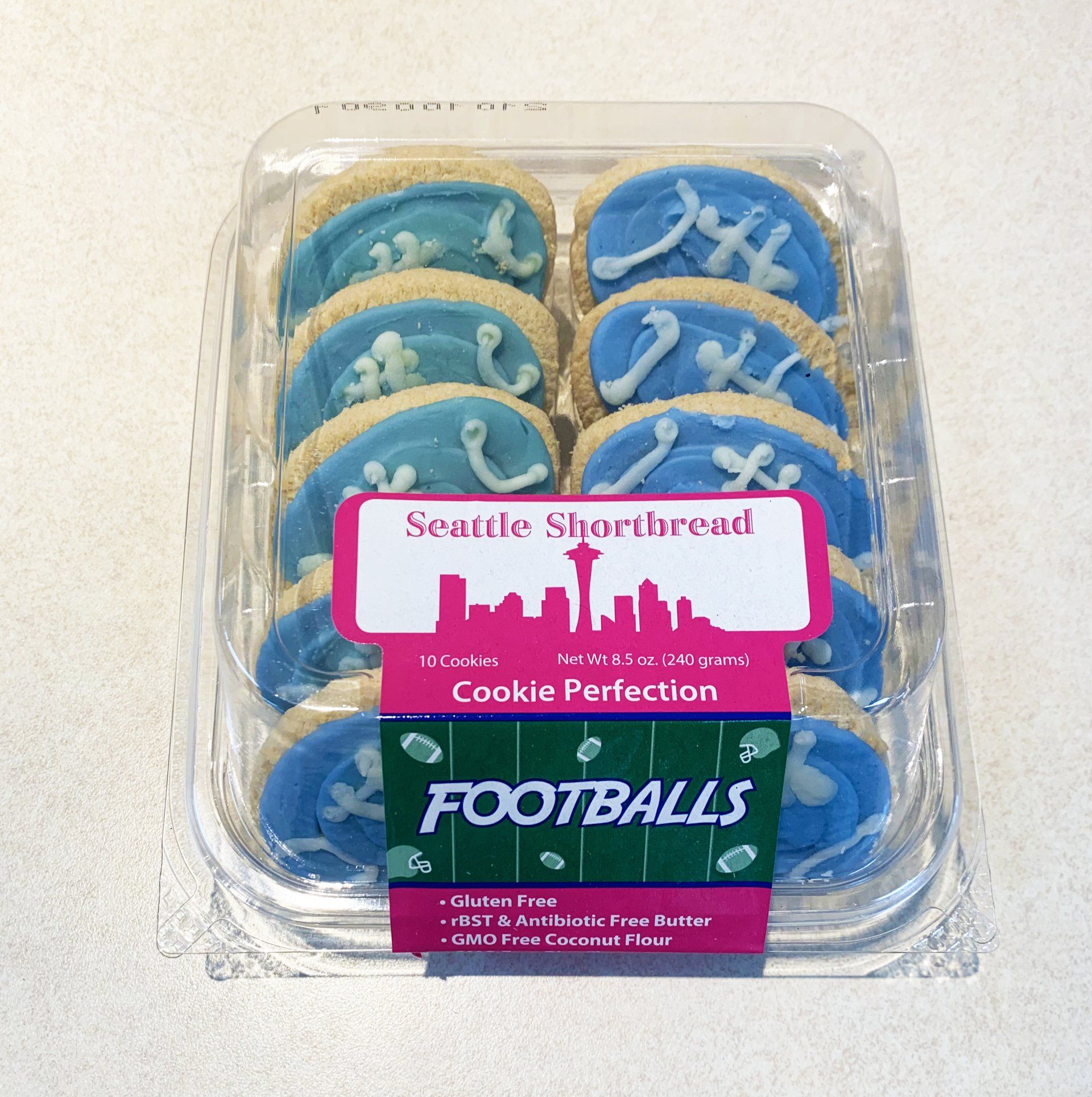 A package of Seattle Shortbread football-shaped cookies with blue icing.