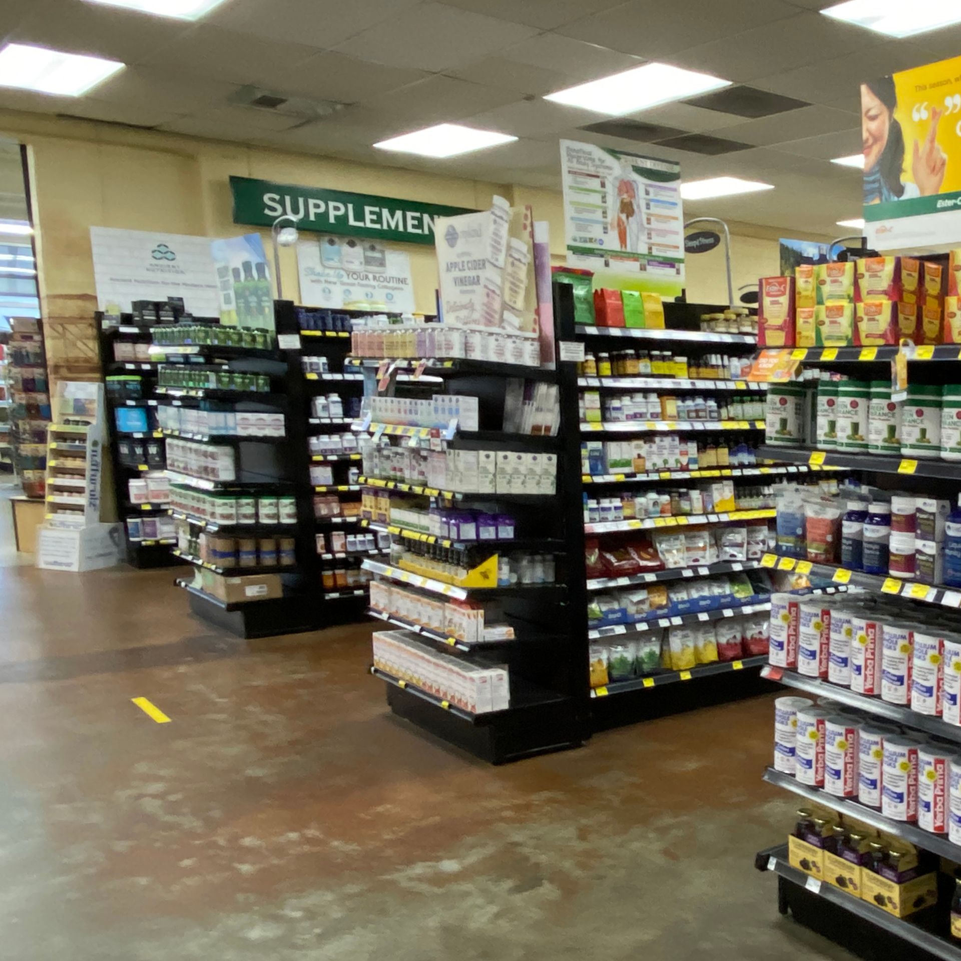 Shelves of dietary supplements in a store, labeled 