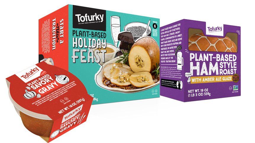 Tofurky plant-based holiday products: a holiday feast box, a ham roast box, and a gravy container.