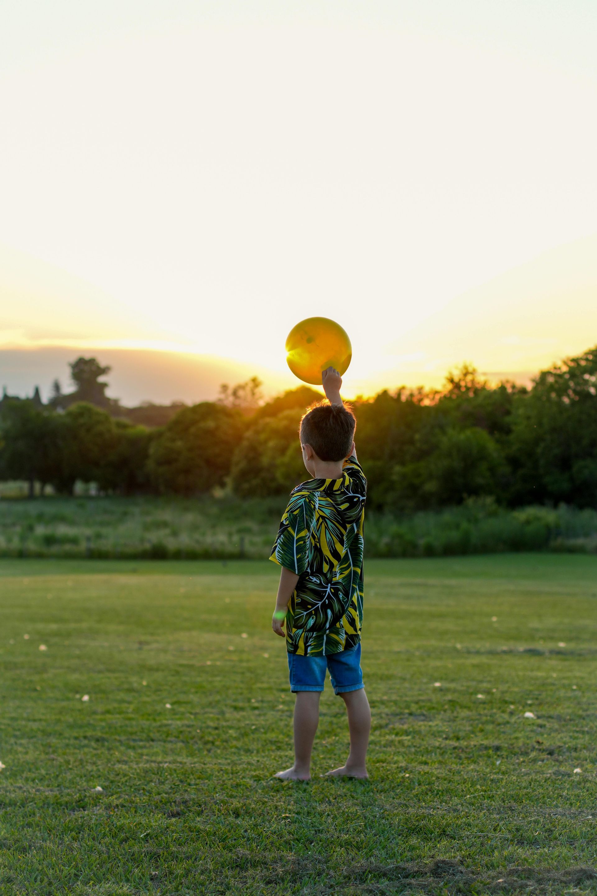 Ski resort with gondola cars ascending the snow-covered mountain. Skiers glide down the slope on a sunny day.