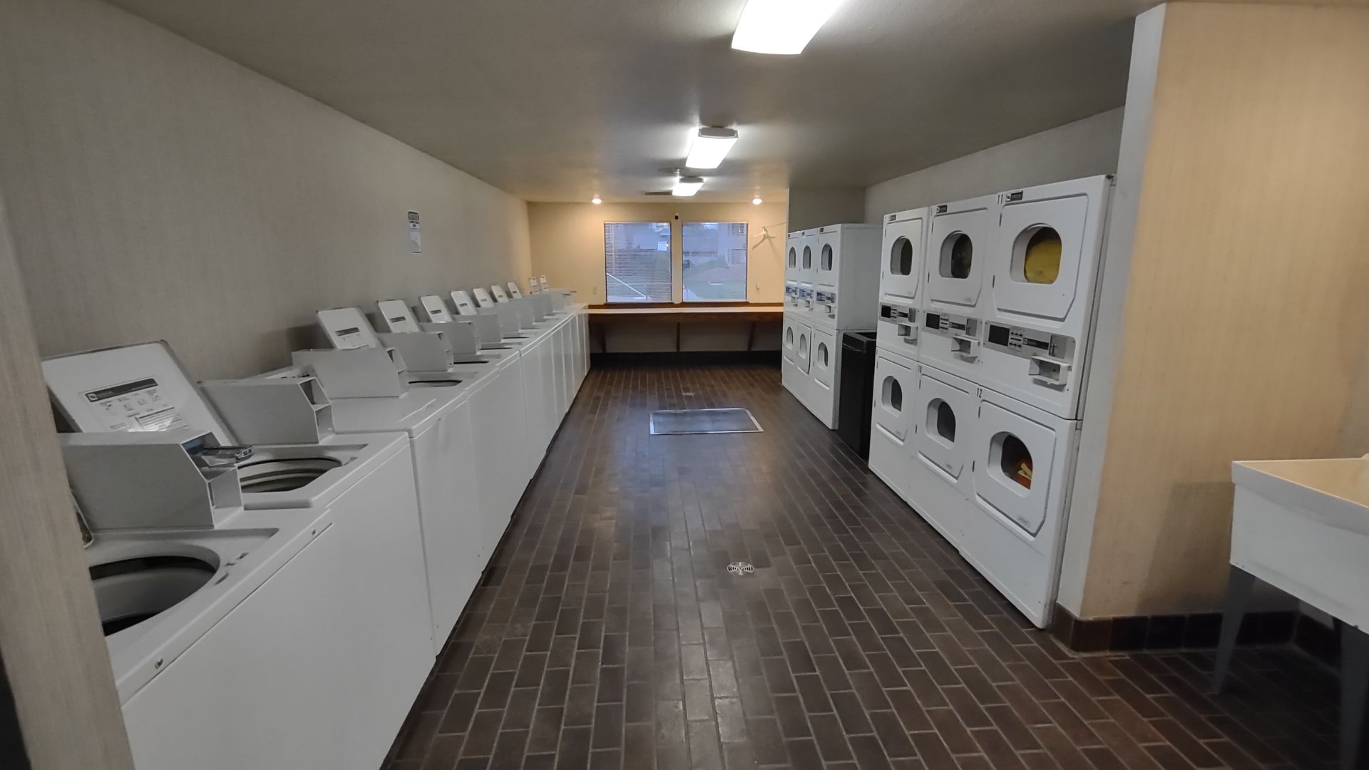 A laundromat with a lot of washers and dryers