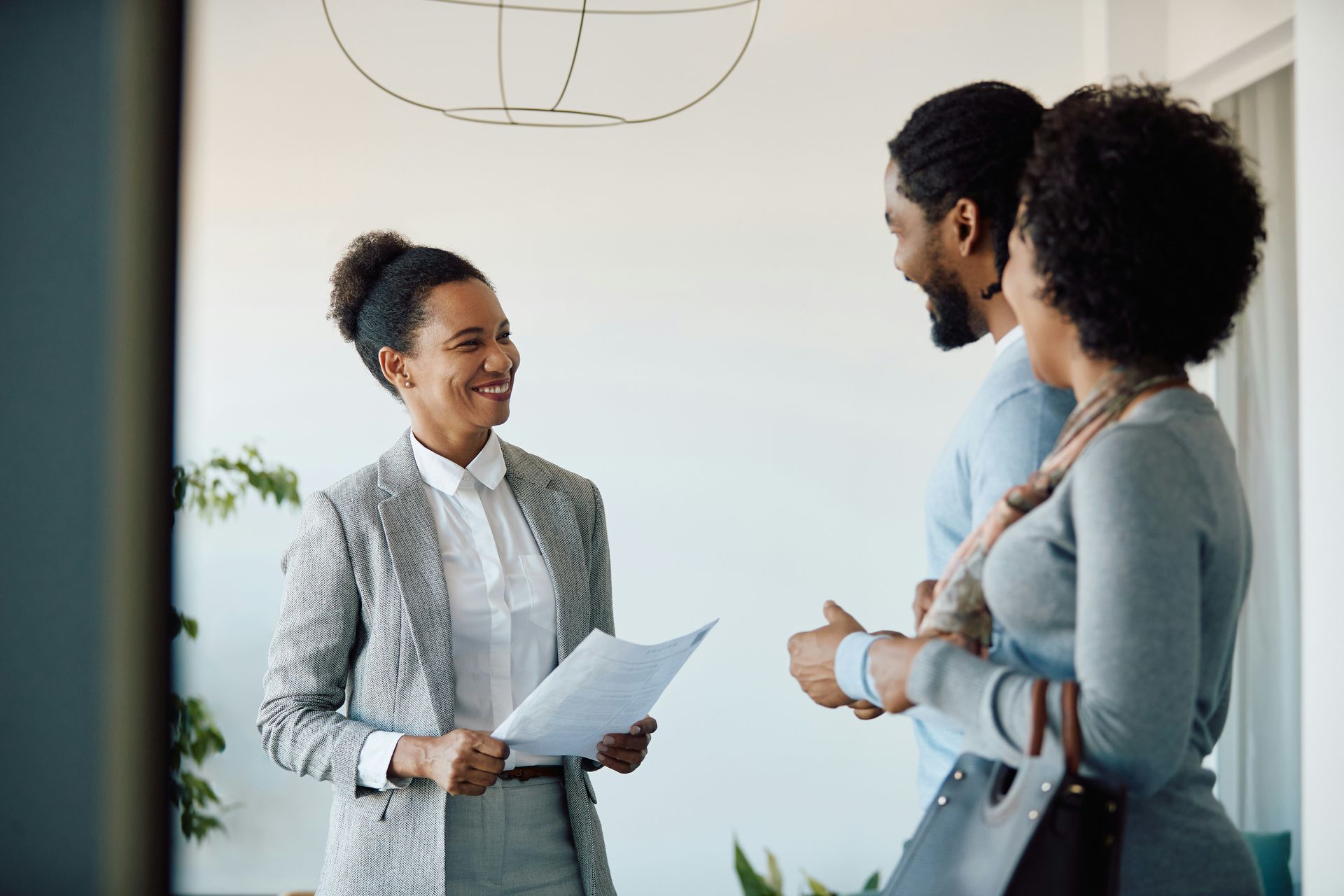 A man in a blue shirt and tie is using a laptop computer.