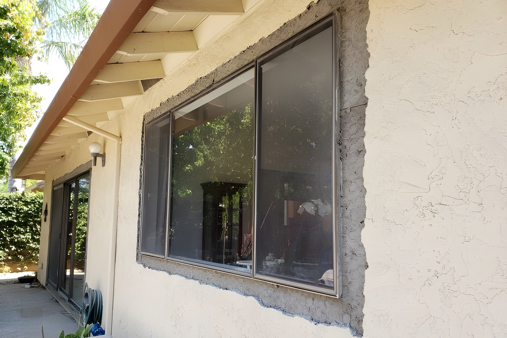 Window with screen in stucco wall.