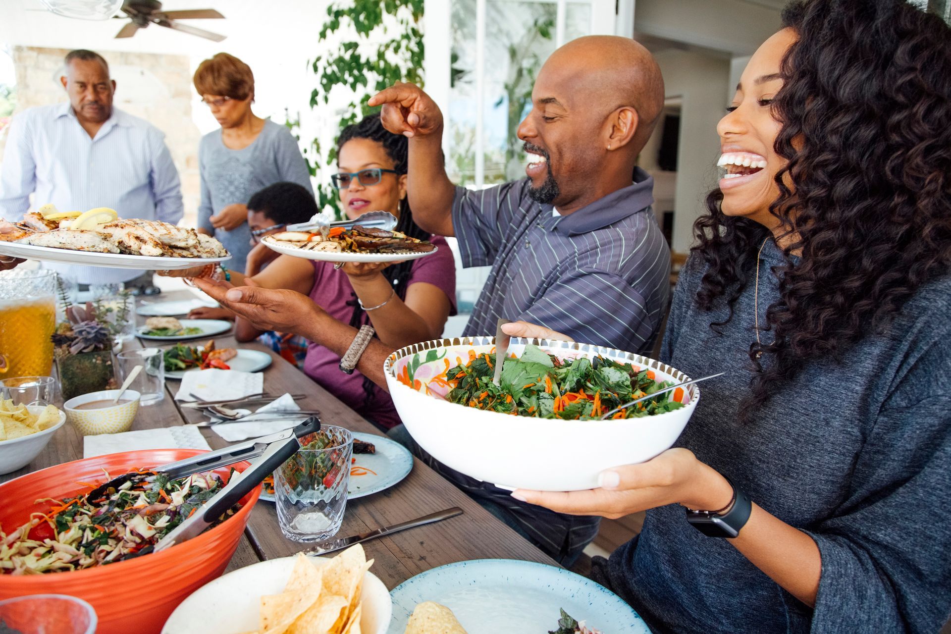 A group of people are sitting at a table eating food.