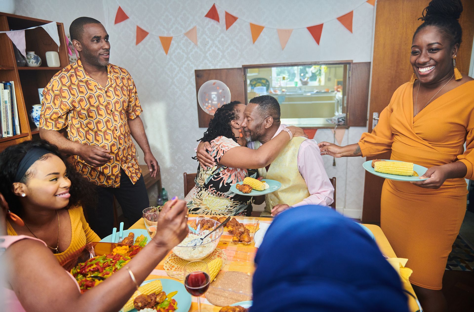 A group of people are sitting around a table eating food.