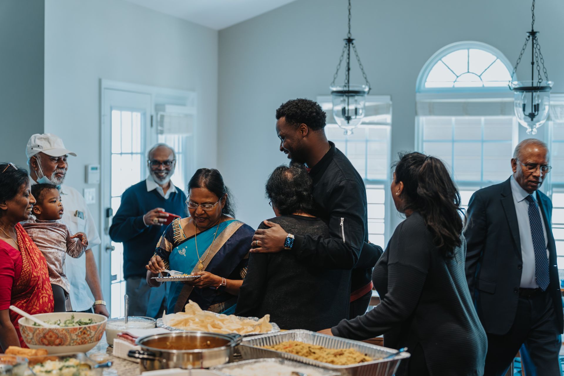 A large group of people are sitting at a long table eating dinner.