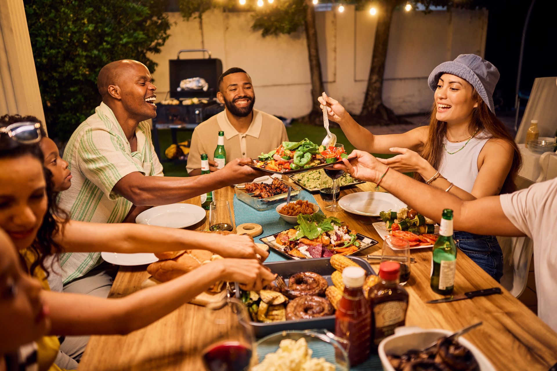 A group of people are sitting around a table eating food.