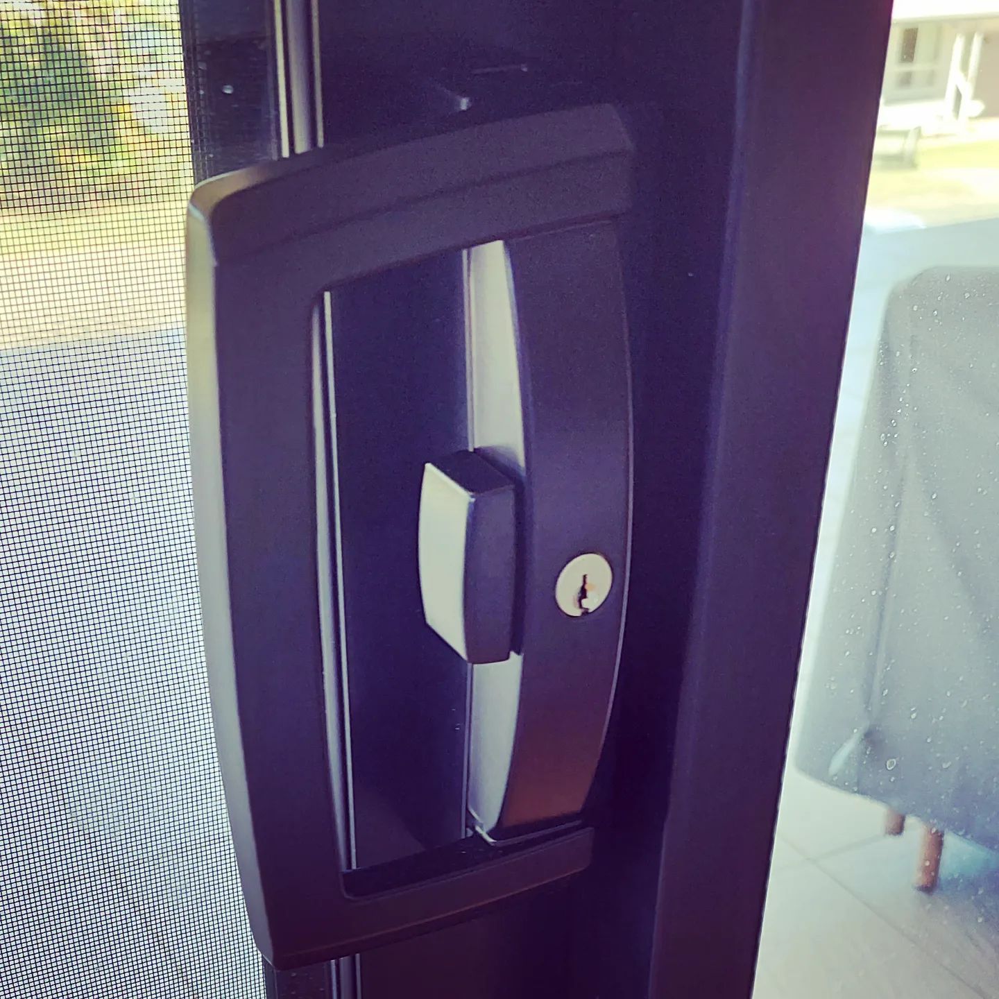 A Close-up of a Black Sliding Door Handle — Above and Beyond Locksmiths in Pimpama, QLD