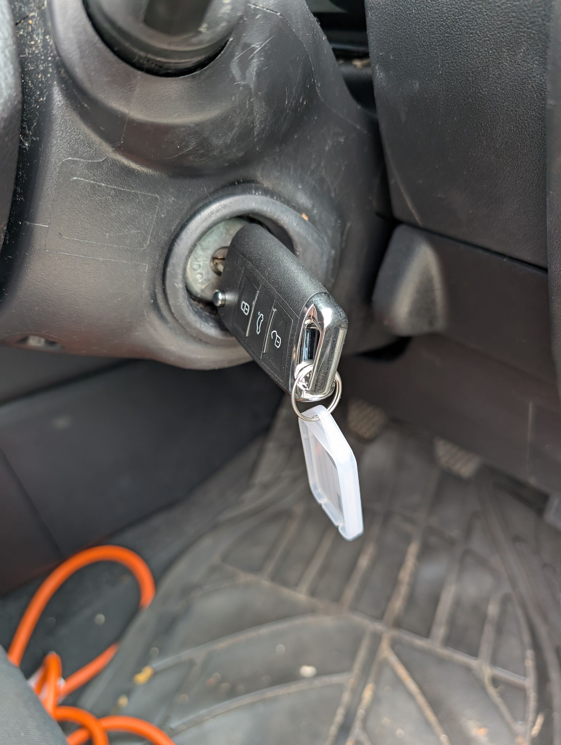 A Black Car Key Inserted Into an Ignition Switch — Above and Beyond Locksmiths in Helensvale, QLD