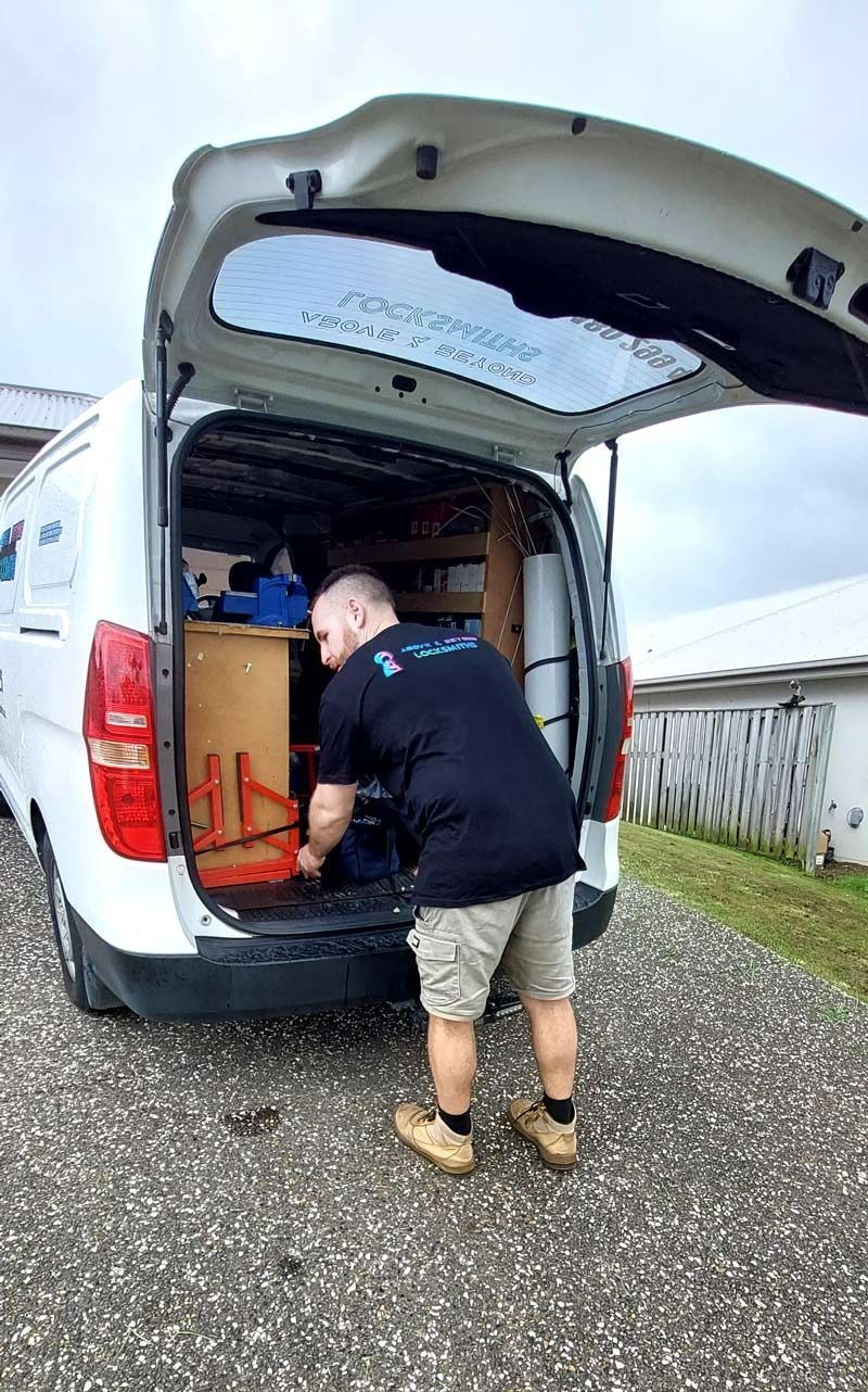 A Technician in a Black T-shirt and Tan Shorts — Above and Beyond Locksmiths in Pimpama, QLD