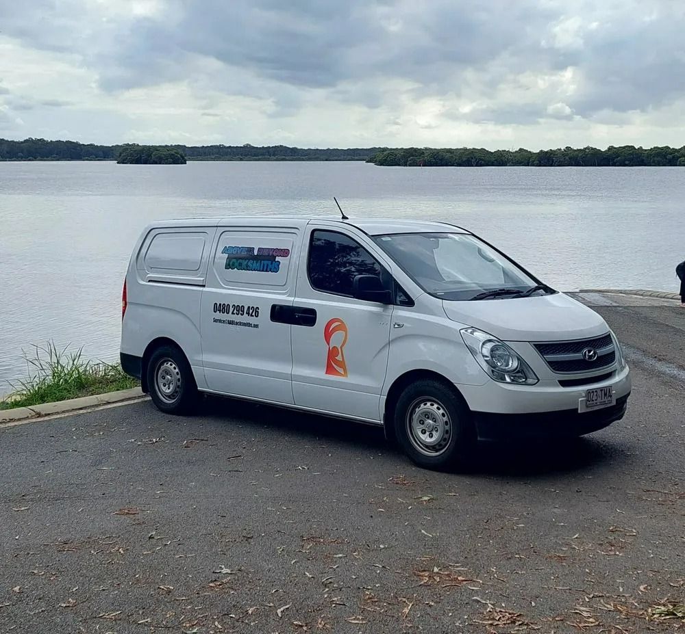 A White Van Parked on a Paved Area — Above and Beyond Locksmiths in Pimpama, QLD
