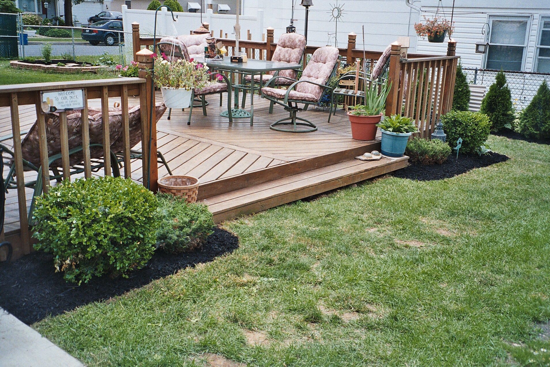 A wooden deck with a table and chairs on it