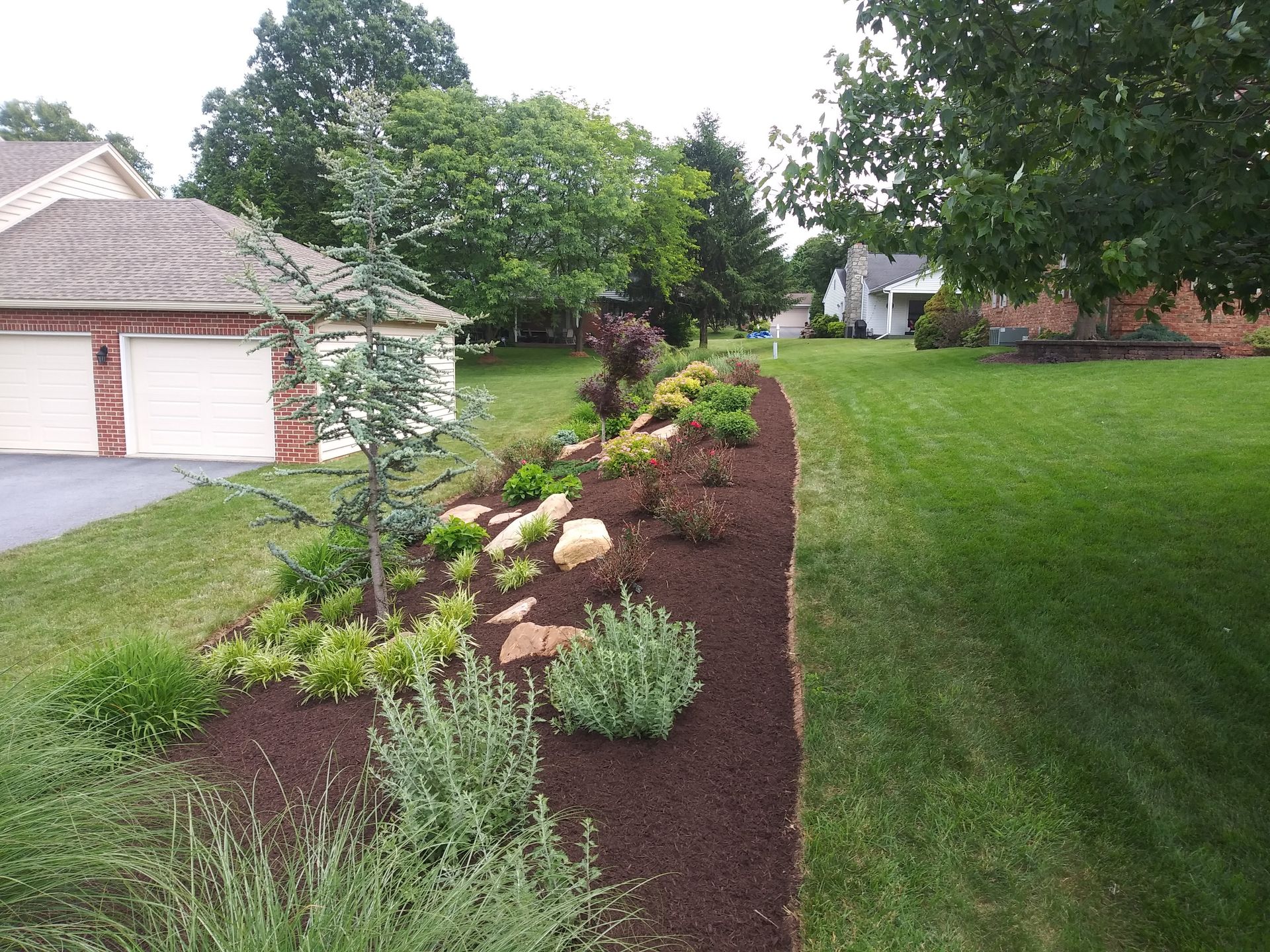 A house with a garage and a lush green yard